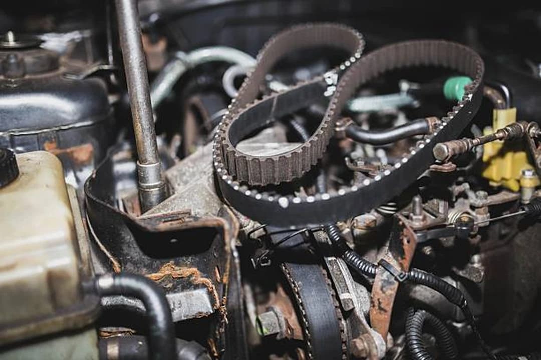 Timing belt and toothed pulleys on an engine ahead of a cam belt replacement at Brilliant Motors Garage, Welling